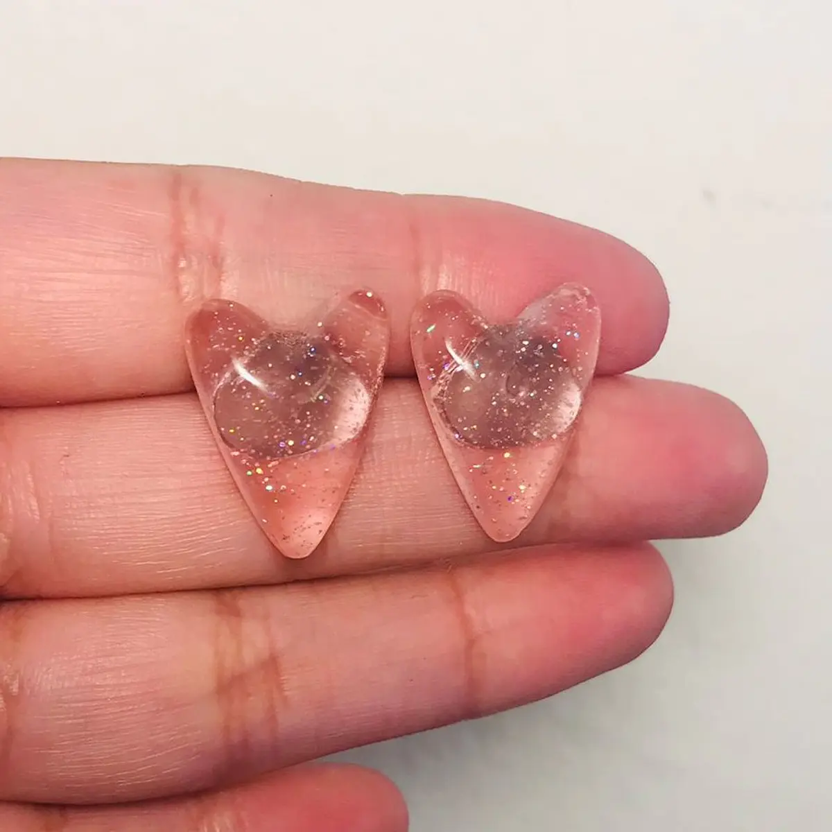 Aritos corazones rosa pálidos brillos translúcidos STOCK